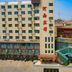 OYO Hexi Hotel in Zhangye, exterior with adjacent modern wing and city street view