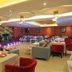 Meshal Hotel & Spa in Manama dining lounge with tables, sofas, stage and ambient ceiling lights