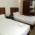 Big Hotel Suites Mandaue City twin room with two single beds and wood wardrobe