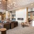 Four Points by Sheraton Elkhart lobby with leather seating, bar shelves and modern fireplace in Elkhart