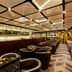 Quentin Boutique Hotel Berlin bar and lounge with leather chairs and mirrored ceiling