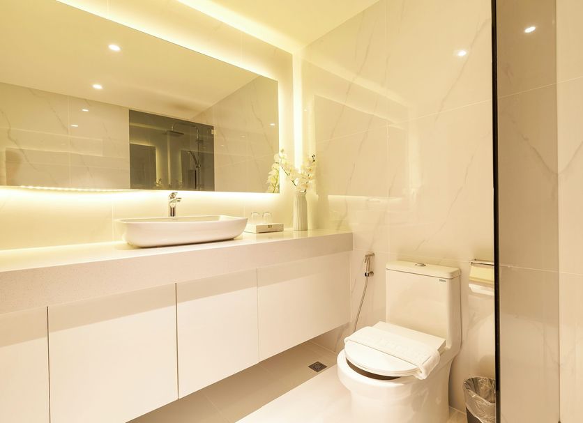 The One Hotel Bay Breeze Pattaya bathroom with vanity, vessel sink, toilet, and glass shower in Pattaya