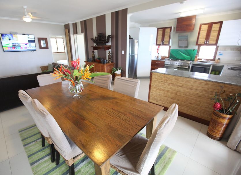 Vanuatu Beachfront Apartments in Port Vila with dining table, lounge and open kitchen interior