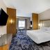 Fairfield by Marriott Inn & Suites Sandusky guest room with king bed, TV, desk, and window seating