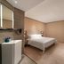 Hanting Hotel Dongguan Changan Wanda guest room with bed, desk, chair, wall-mounted TV and sink in Dongguan