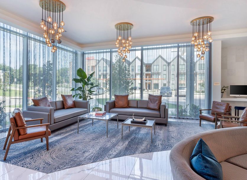 Cambria Hotel Waco University Riverfront lobby with floor-to-ceiling windows and city views