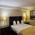 Marvin's Garden Inn Southfield guest room with bed, nightstands and lamps