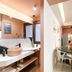 Pavo Art Hotel Heraklion interior with vanity sink, dining table and sofa in a bright suite