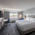 Crowne Plaza Ft. Myers Gulf Coast guest room with king bed, desk, and water view in Fort Myers