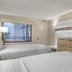 Fun-Filled Oasis near Disney Springs hotel room in Lake Buena Vista with two beds and wall-mounted TV