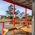 Kaikoura TOP 10 Holiday Park in Kaikoura: red-porch view of cabins, picnic tables and gravel grounds