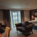 Dunadry Hotel And Gardens in Antrim bedroom with king bed, armchair, and balcony doors