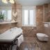 Priska Heritage Rooms Split bathroom with marble tile, pedestal sink, wall toilet and window