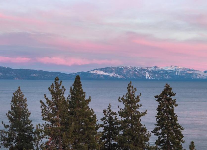 evo Hotel Tahoe City with lake and snowcapped mountain views at sunset in Tahoe City