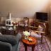 Beaufort House Inn in Asheville living room with sofa, chairs, TV, coffee table and fireplace