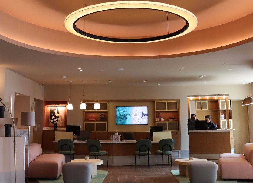 Novotel Mexico City Santa Fe lobby with circular ceiling light, front desk and lounge seating in Mexico City