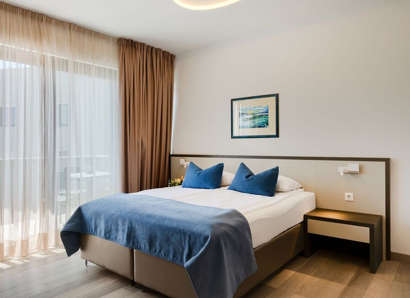 Pula City Center Accommodation in Pula, guest room with bed, blue throw, and balcony doors