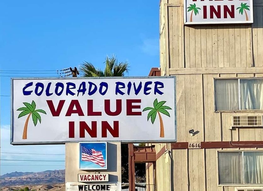 Colorado River Value Inn in Bullhead City exterior with vacancy sign and palm-themed signage