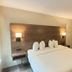 Baymont by Wyndham Lake Park Valdosta I75 guest room with king bed and wood headboard in Lake Park