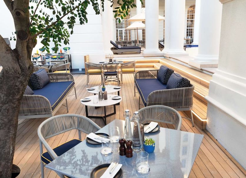 Southern Sun The Cullinan Cape Town outdoor terrace dining area with tables, chairs and lounge seating