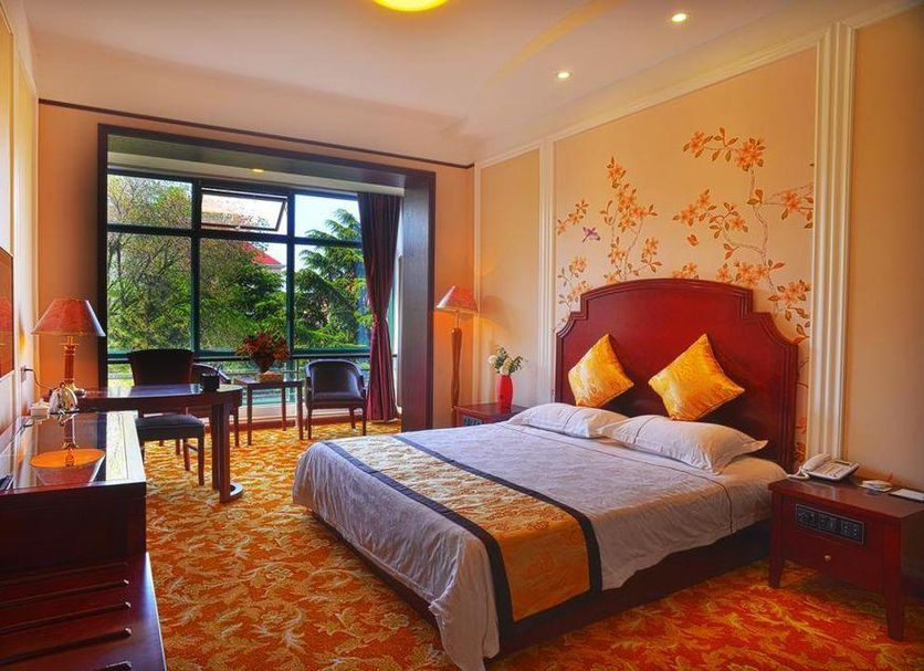 Sea Shore Garden Hotel Qingdao room with king bed, balcony and garden view in Qingdao