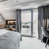 Der Öschberghof in Donaueschingen bedroom with balcony doors to a terrace and golf course view