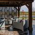 Hilton Garden Inn Topeka gazebo seating area with cushioned chairs and fire pit