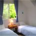 Pension Wave Inn in Itō twin room with two single beds and windows overlooking greenery