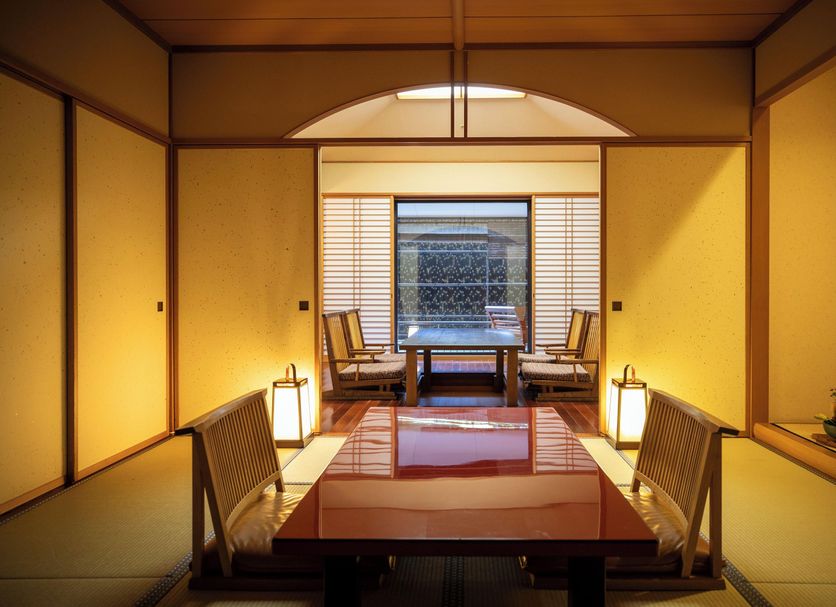 Hotel Nanpuso in Hakone traditional tatami room with low table, floor chairs, and garden view