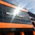 Hotel Flert Santana in Sao Paulo exterior with black facade, orange accents, and sun glare