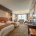 Li An Hotel Hohhot guest room with two twin beds, sofa seating, and a large window