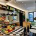 citizenM Rome Isola Tiberina lobby café with checkered floor, food display, and seating in Rome