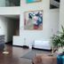 Hotel Los Españoles Plus Santiago lobby with front desk, modern art and seating area