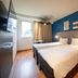 ibis Nogent-sur-Marne twin room with two beds, blue accent wall and window light in Nogent-sur-Marne