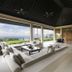 The Ungasan Clifftop Resort in South Kuta lounge opens to ocean and garden views through wide glass walls.