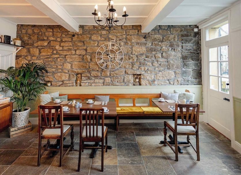 Weavers Guesthouse by Weavers of Haworth in Keighley breakfast room with stone wall and dining tables