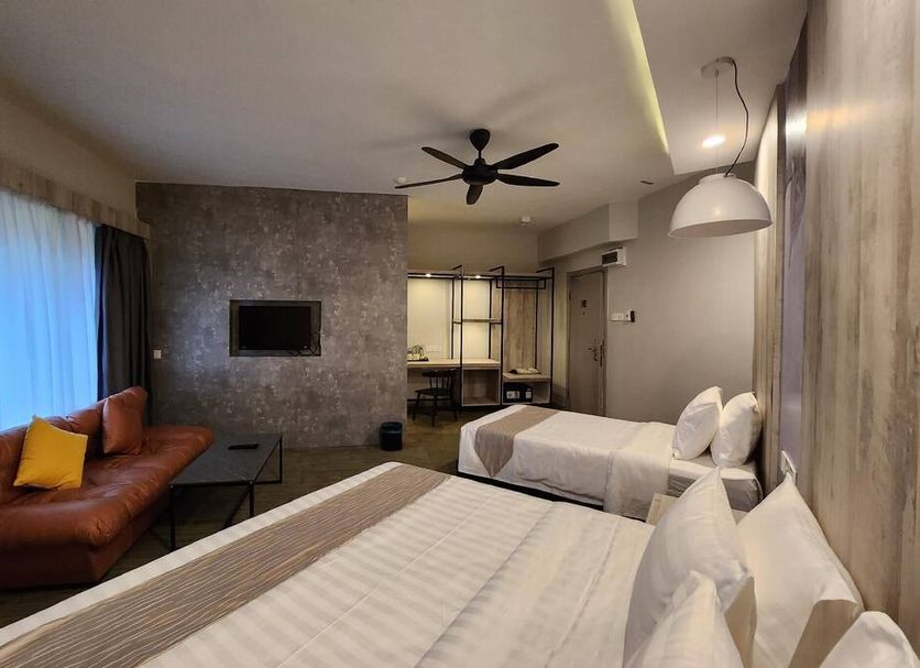 Perkasa Hotel Mt Kinabalu room with two beds, sofa and wall-mounted TV in Kampung Kigiok