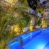 Hotel El Marqués by Faranda Boutique in Cartagena, stone courtyard with illuminated blue pool and tropical plants