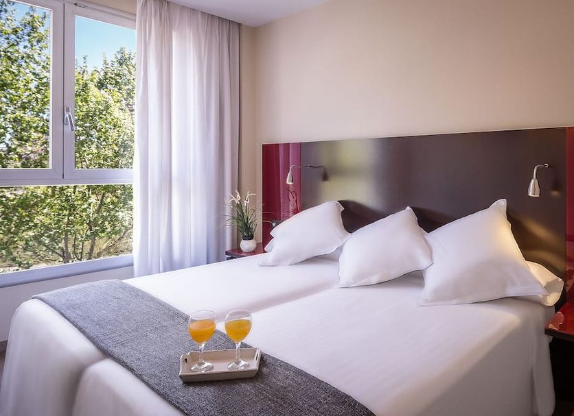 Sm Hotel Teatre Auditori Barcelona guest room with twin bed and large window view