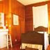 Casa 325, Key West: cozy wood-paneled guest room with a bed, bedside lamp, and small sink area