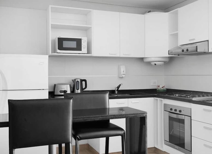 CH Recoleta Suites Buenos Aires kitchen with dining table, refrigerator, microwave, stove and oven