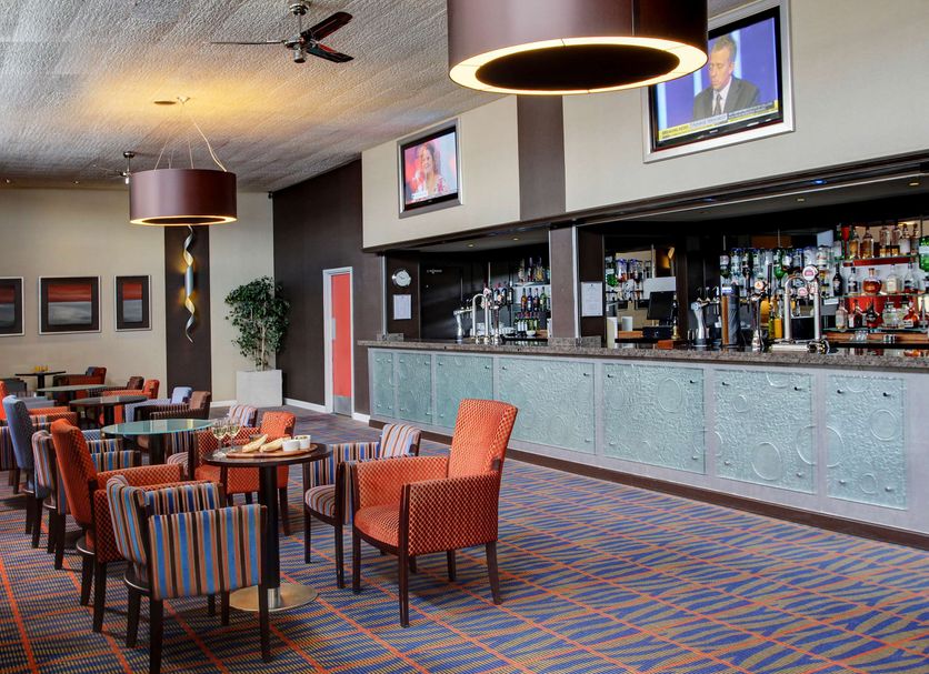Best Western Aberavon Beach Hotel bar lounge in Port Talbot with tables, chairs and mirrored back bar