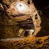 Posada Puerto Bemberg in Puerto Libertad, rocky cave-like interior with warm lights and rugged stone walls