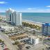 The anchor hotel in Myrtle Beach with oceanfront towers, beach, road, and parking lots