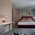 123 Mainstreet Boutique Hotel in St. Julian's guest room with king bed, desk, and large window