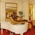 Grand Hotel La Pace, Sorrento: elegant lobby with a white grand piano and gold sculpture.