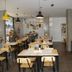 Epico Recoleta Hotel Buenos Aires restaurant with wooden tables, pendant lights and plants