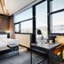 B&B Hotel München-Moosach room in Munich with king bed, desk, and large windows