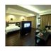 The Pearl Boutique Hotel Lishui suite with bed, sofa, TV and floor-to-ceiling curtains