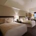 Hotel Kuva Chateau in Taoyuan City guest room with two beds, desk and city view